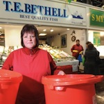 Sue Leeming, is using buckets to prevent water from a leaking roof flooding her shop. PIC: Mark Bickerdike
