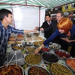 Mary Portas tries some olives on Surrey Street Market.