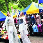 Stilt-walkers Andy Wakeford and Helena Parsons welcome visitors to the new-look Gloucester Green market on Wednesday