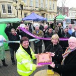 Wiltshire Council market officer Lisa McKee, trader Karen Miller Ward who made the cake, and David Baker of the Town Team along with traders celebrating the success of the market Photo: Trevor